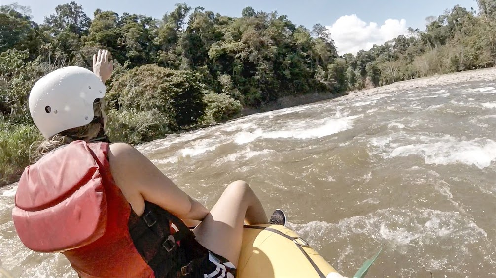 Young woman Whitewater Rafting a Class III rapid on the Balsa River in Costa Rica