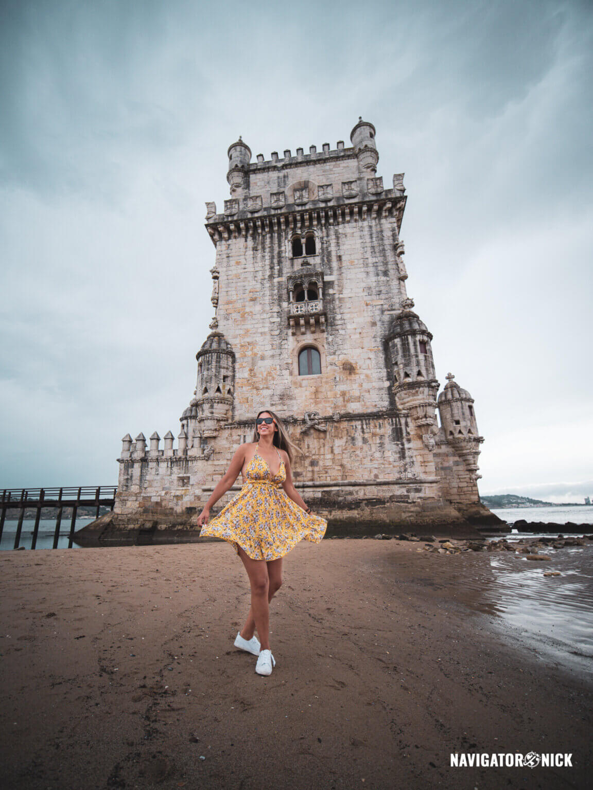 Woman dances near Belém Tower of Saint Vincent in Lisbon