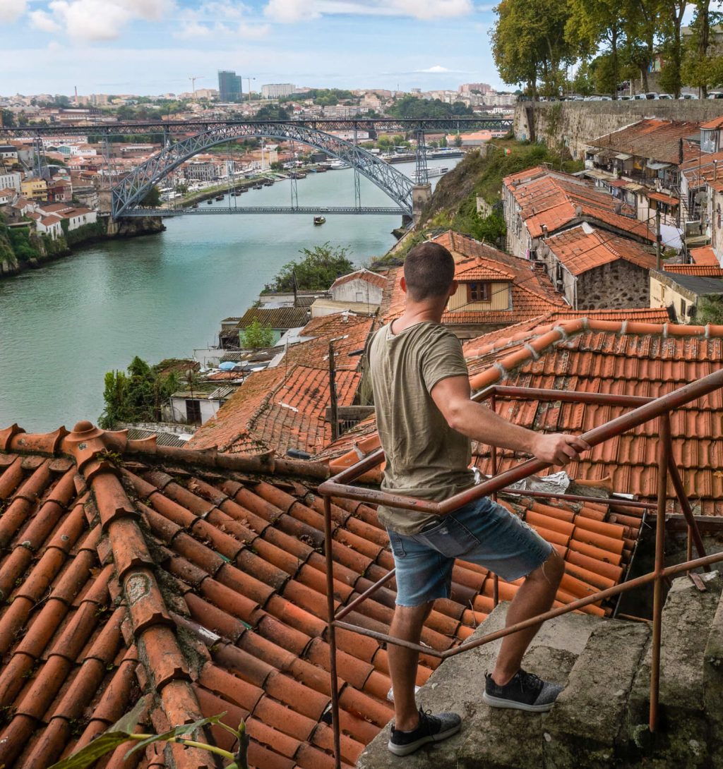 Man looks over Douro River in Porto Portugal